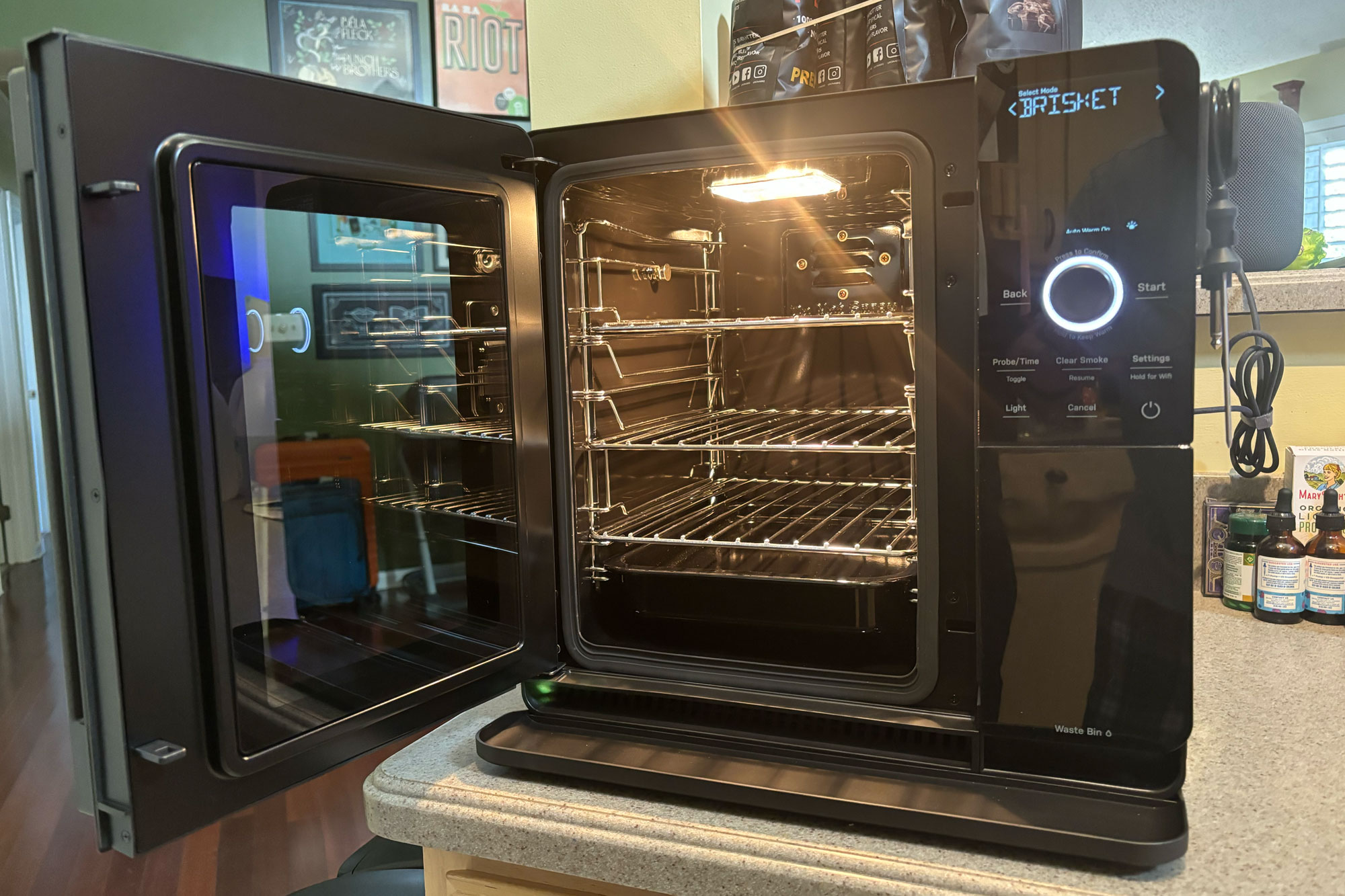 GE Profile Smart Indoor Smoker with the door open, showing the three removable racks.