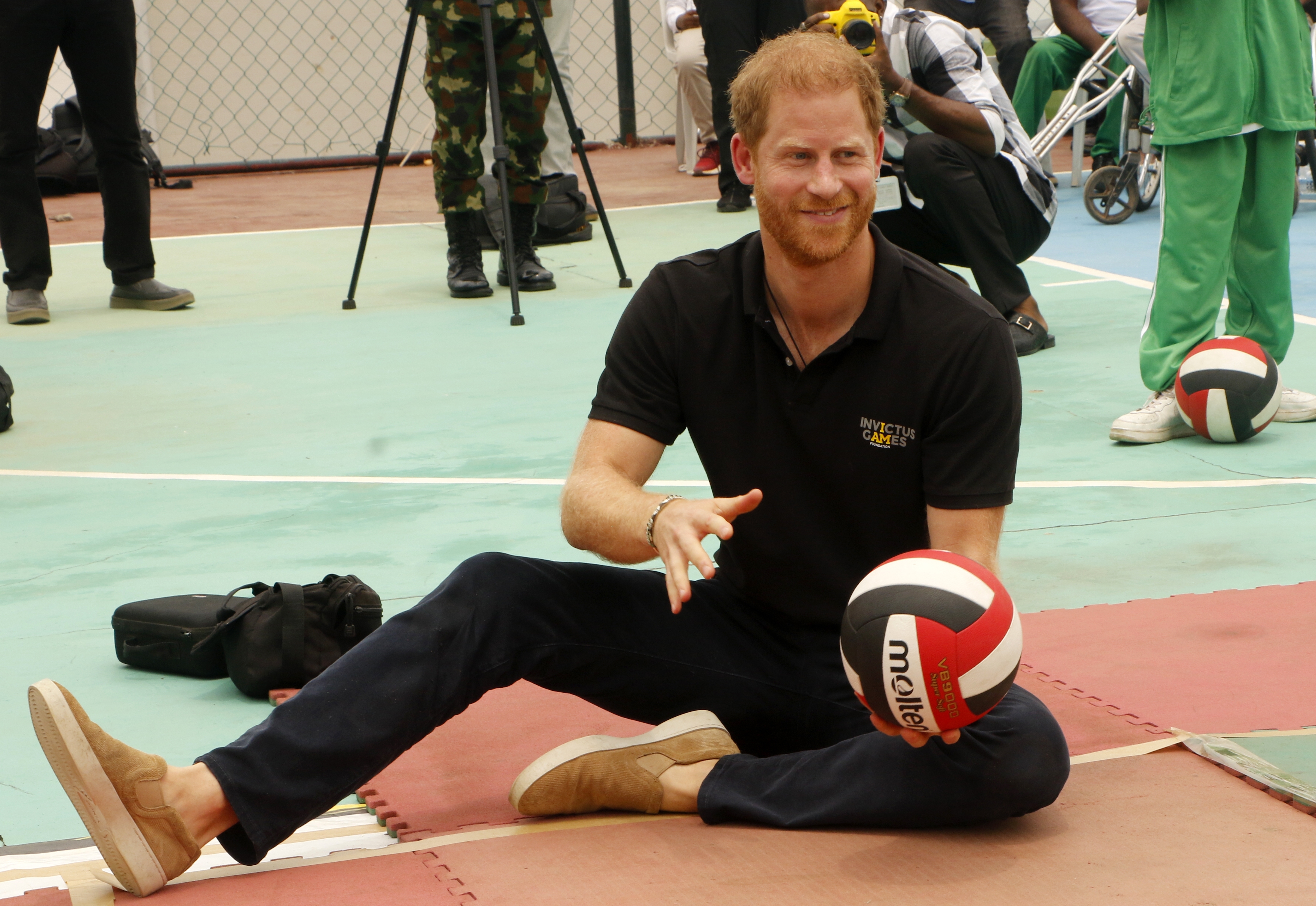 ABUJA, NIREGIA - MAY 11: Britain's Prince Harry, Duke of Sussex, and Britain's Meghan (not seen), Duchess of Sussex, attend an exhibition sitting volleyball match at Nigeria Unconquered, a community-based charitable organization dedicated to aiding wounded, injured, or sick servicemembers, as part of celebrations of Invictus Games anniversary in Abuja, Nigeria on May 11, 2024. (Photo by Emmanuel Osodi/Anadolu via Getty Images)
