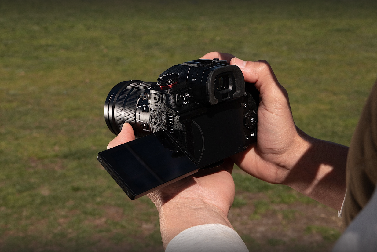 A hand holding a camera.