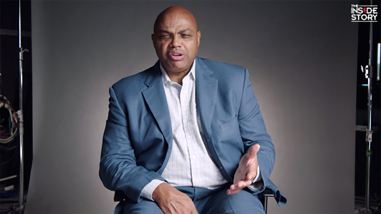 Charles Barkley sitting in a studio chair, a look of disbelief on his face.