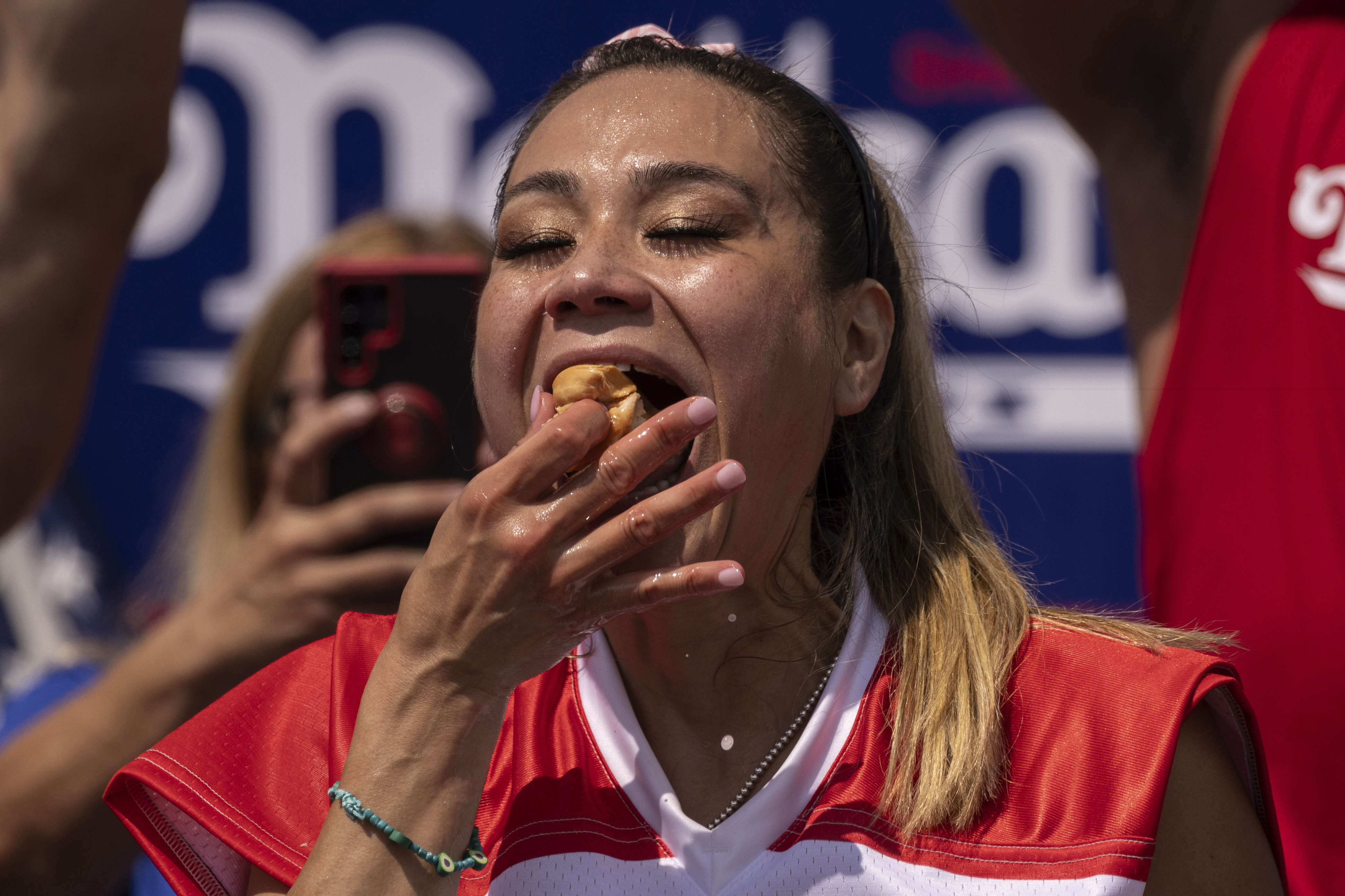 FILE - Competitive eater Miki Sudo eats a hot dog during the 2023 Nathan's Famous Fourth of July hot dog eating contest in the Coney Island section of the Brooklyn borough of New York, July 4, 2023. The annual Nathan’s Famous Fourth of July hot dog eating contest will see a slate of competitive eaters wolf down as many franks as they can in New York City on Thursday, July 4, 2024. (AP Photo/Yuki Iwamura, File)