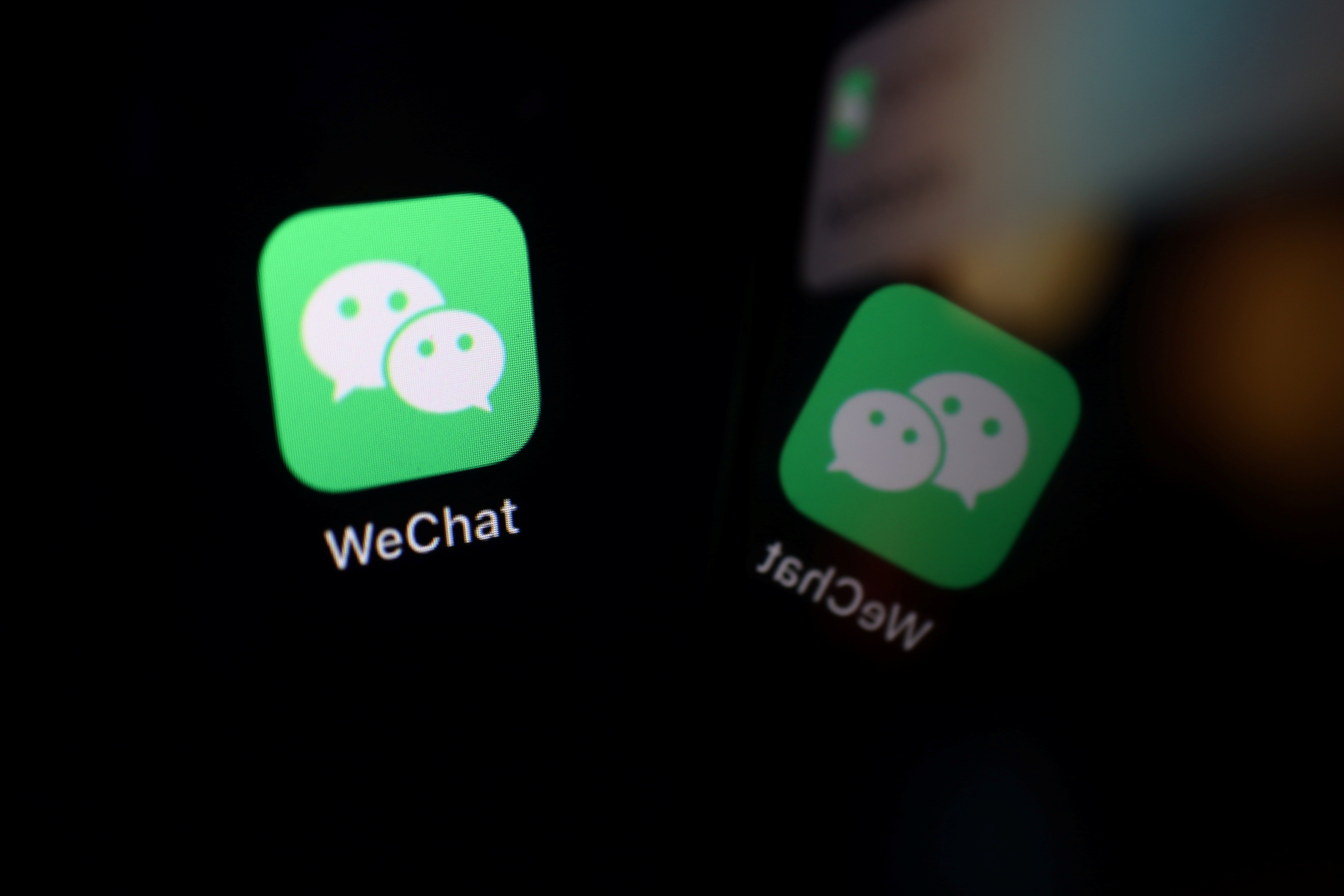 The sign of the WeChat app is seen reflected on a mobile phone in this illustration picture taken September 19, 2020. REUTERS/Florence Lo/Illustration