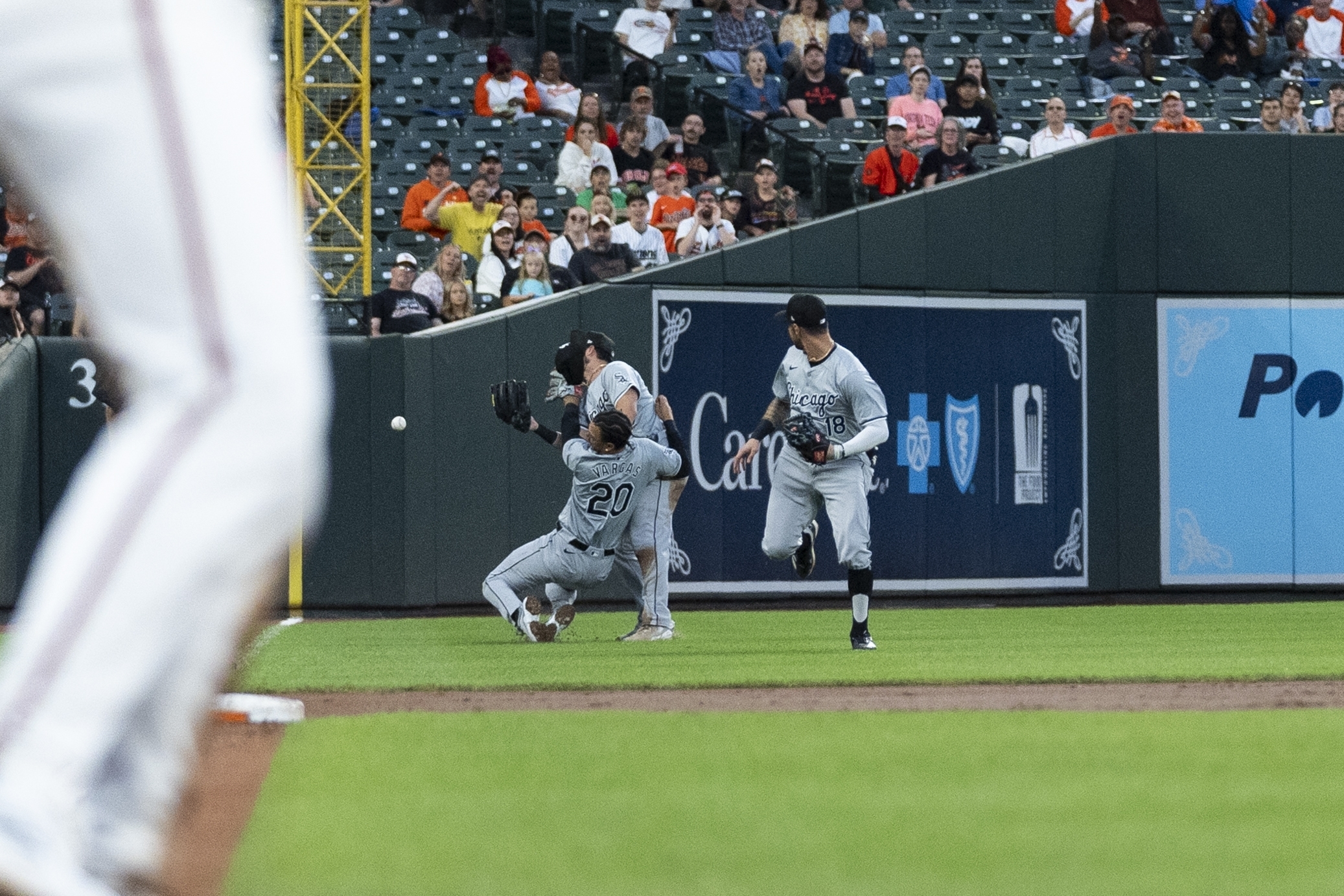 Chicago White Sox third baseman Miguel Vargas (20) collides with left fielder Andrew Benintendi, center, and is unable to catch a fly ball hit in by Baltimore Orioles' Eloy Jimenez during the second inning of a baseball game, Tuesday, Sept. 3, 2024, in Baltimore. (AP Photo/Stephanie Scarbrough)