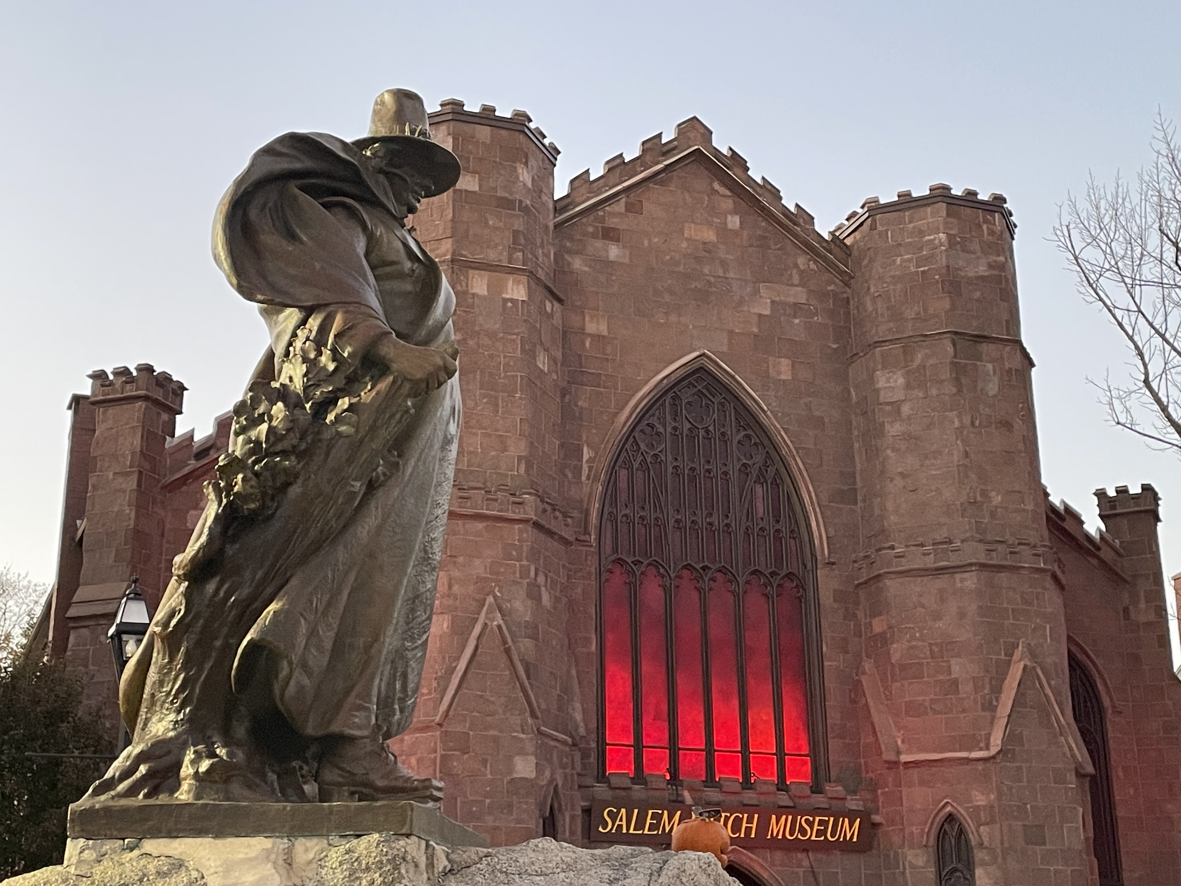 Salem MA, USA October 27 A statue of Roger Conant, the founder of Salem, Massachusetts, stands in front of the Salem Witch Museum, housed in a church-like building