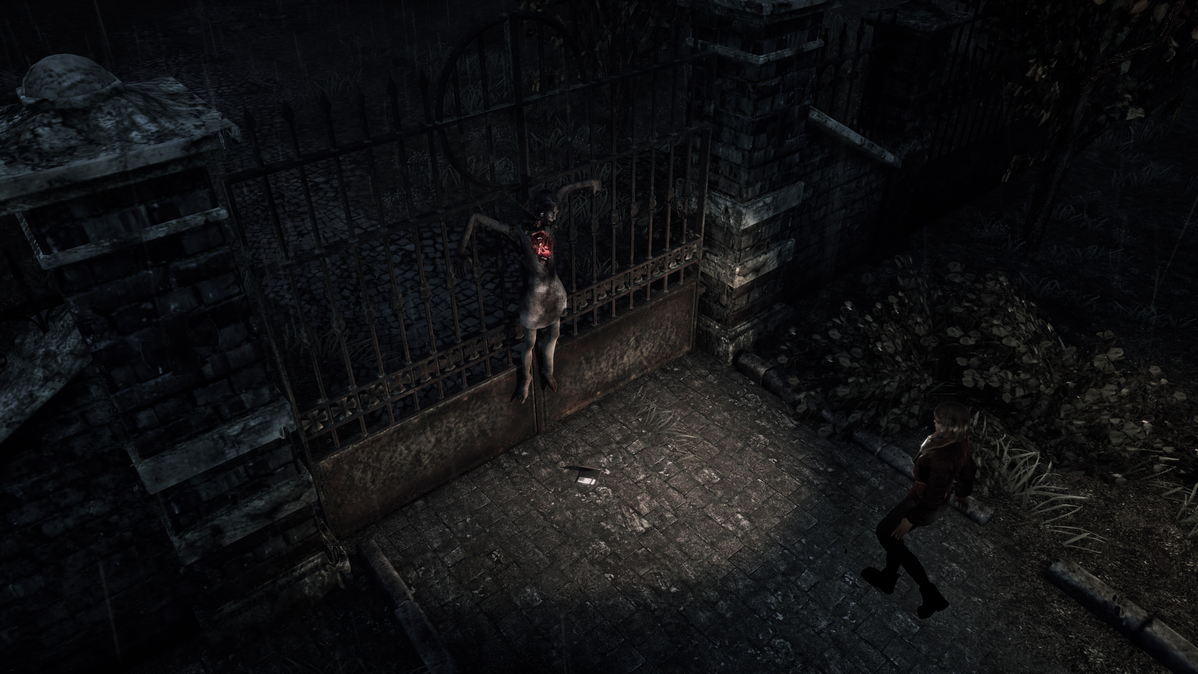 A woman's body is strung to an iron gate in the middle of a cobblestone path. Mica is seen walking toward her, shining her light on the corpse