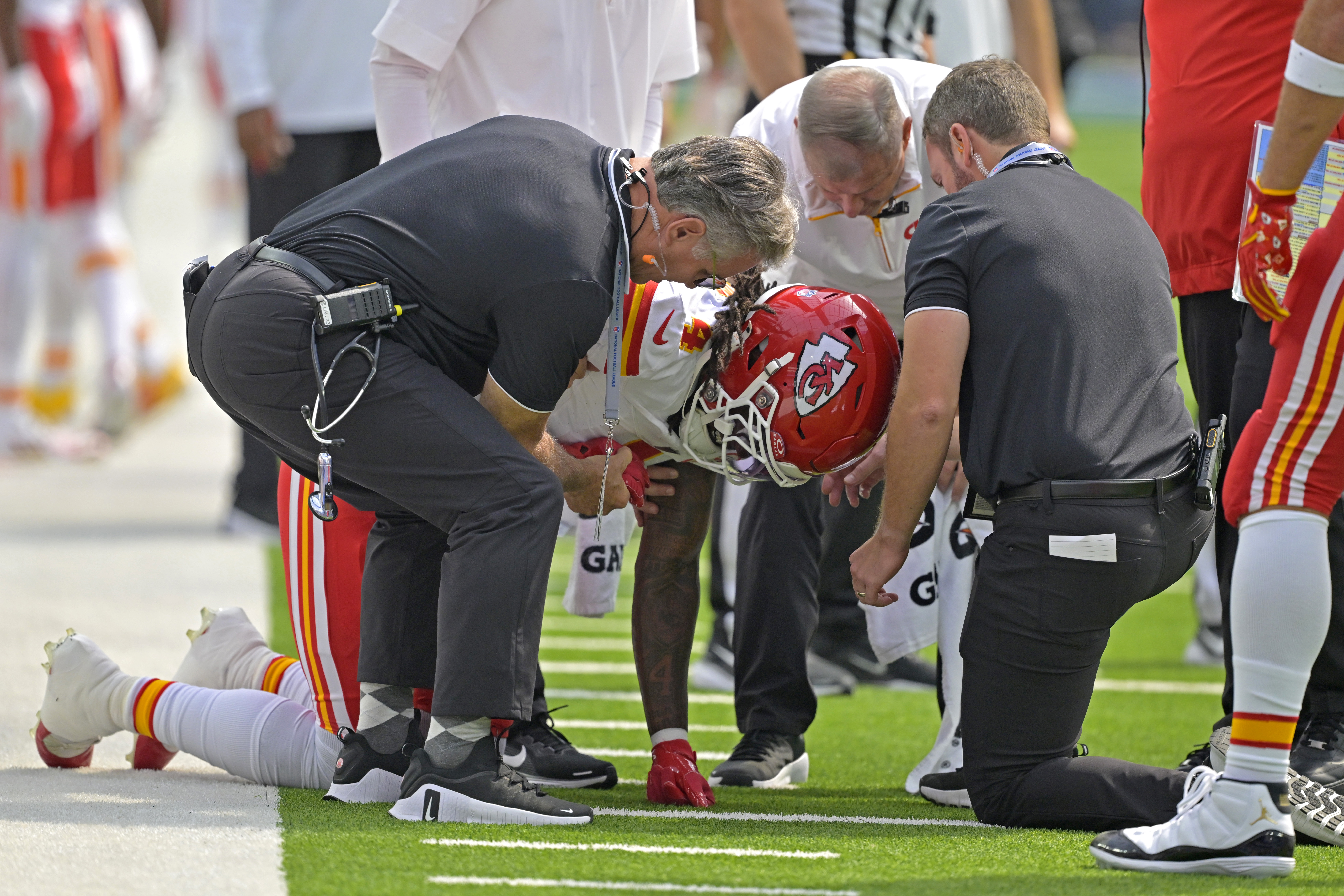 Sep 29, 2024; Inglewood, California, USA;  Kansas City Chiefs wide receiver Rashee Rice (4) pounds his fist on the ground after an injury in the first half against the Los Angeles Chargers at SoFi Stadium. Mandatory Credit: Jayne Kamin-Oncea-Imagn Images