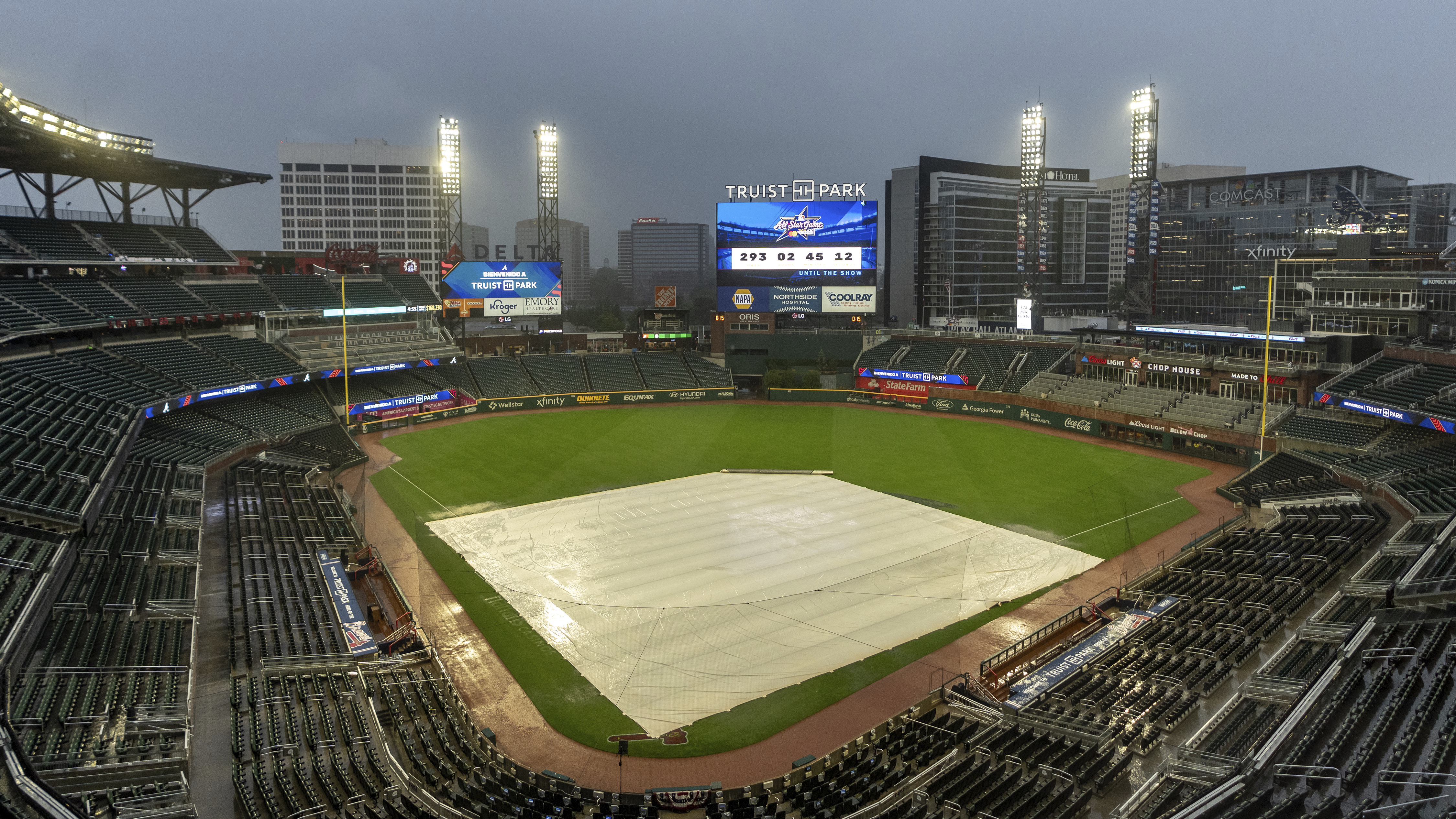 A tarp covers the infield as rain comes down at Truist Park after the Mets and Braves was postponed, Wednesday. (AP Photo/Jason Allen)