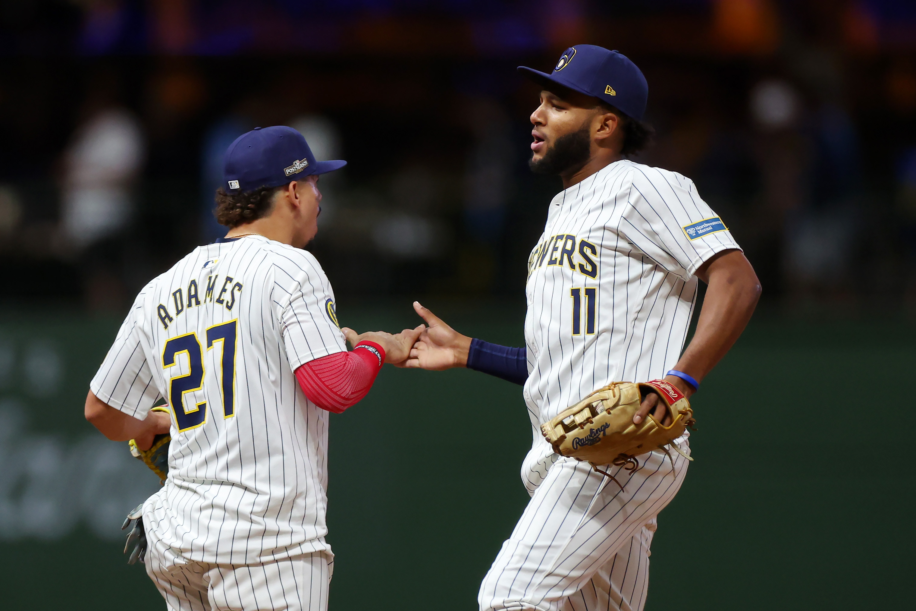 MILWAUKEE, WISCONSIN - OCTOBER 02: Willy Adames #27 and Jackson Chourio #11 of the Milwaukee Brewers celebrate after beating the New York Mets 5-3 in Game Two of the Wild Card Series at American Family Field on October 02, 2024 in Milwaukee, Wisconsin.  (Photo by Stacy Revere/Getty Images)