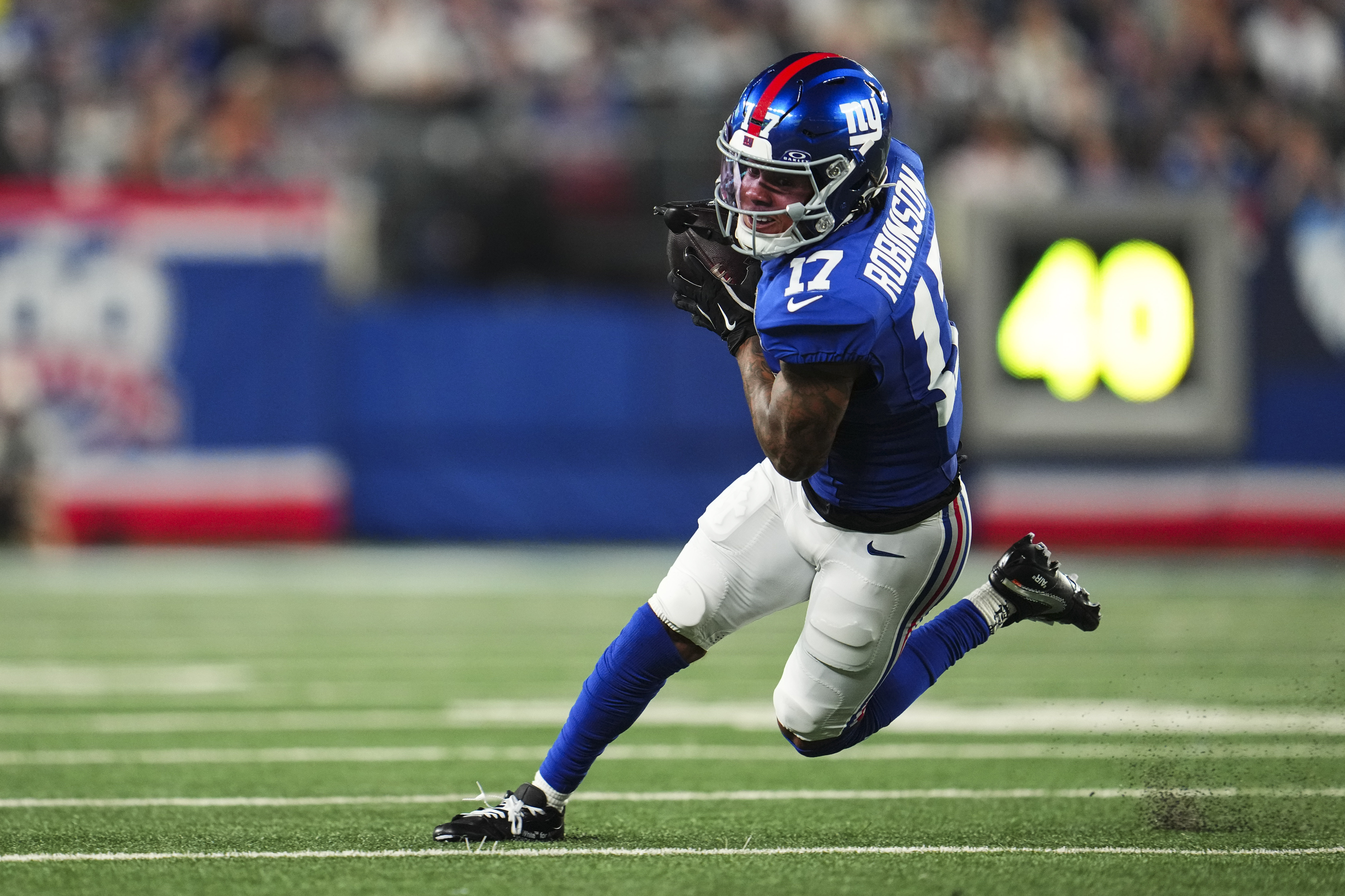 EAST RUTHERFORD, NJ - SEPTEMBER 26: Wan'Dale Robinson #17 of the New York Giants runs the ball during an NFL football game against the Dallas Cowboys at MetLife Stadium on September 26, 2024 in East Rutherford, New Jersey. (Photo by Cooper Neill/Getty Images)