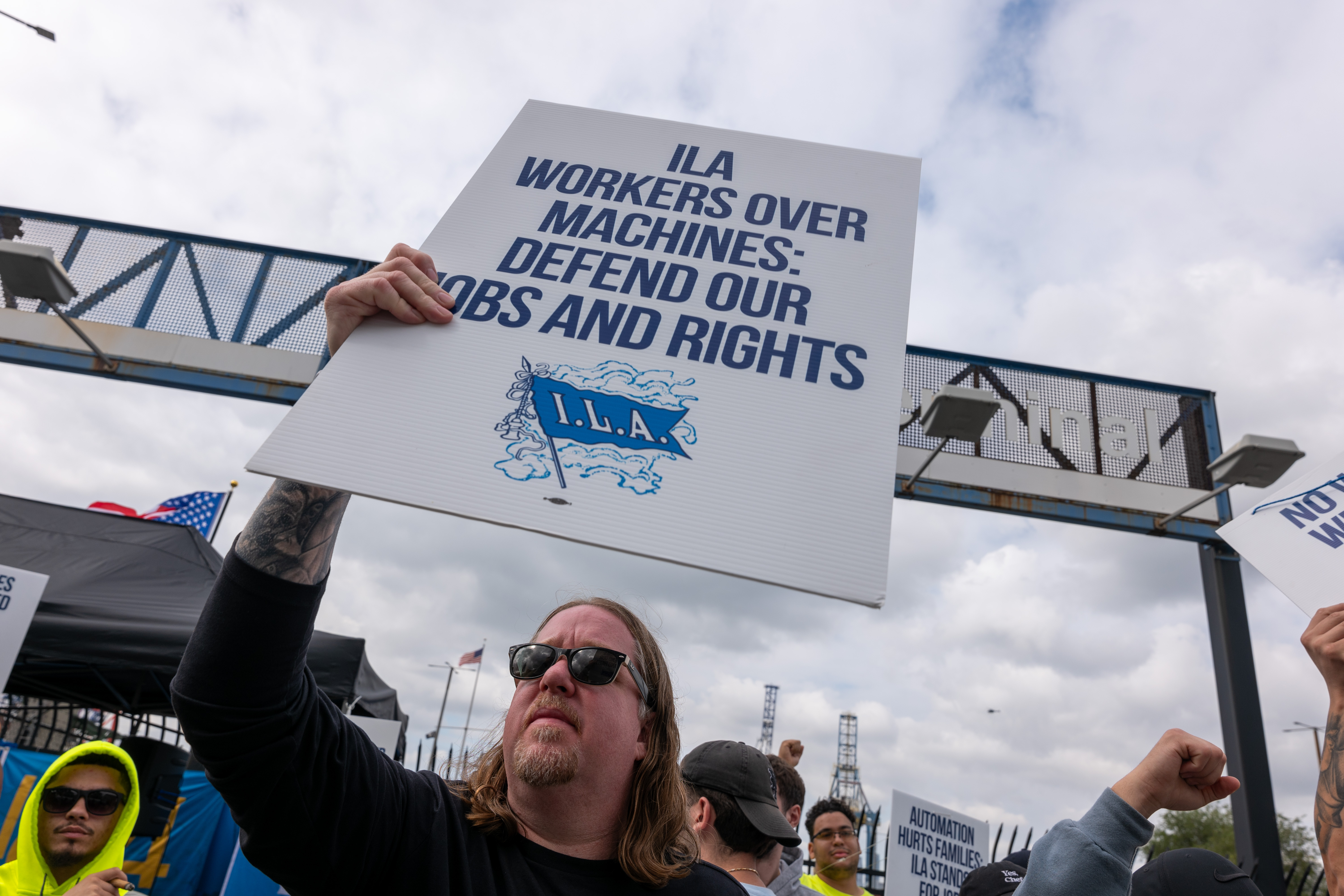 NEW YORK, NEW YORK - OCTOBER 02: Striking workers at the Red Hook Container Terminal in Brooklyn gather after members of the International Longshoremen’s Association, or ILA, began walking off the job yesterday after 12:01 a.m. ET on October 02, 2024 in Brooklyn, New York. The strike of over 50,000 workers at ports along the East Coast and Texas comes after the just-expired master contract with the United States Maritime Alliance, or USMX. Workers are striking over wages, automation, and other issues. (Photo by Spencer Platt/Getty Images)