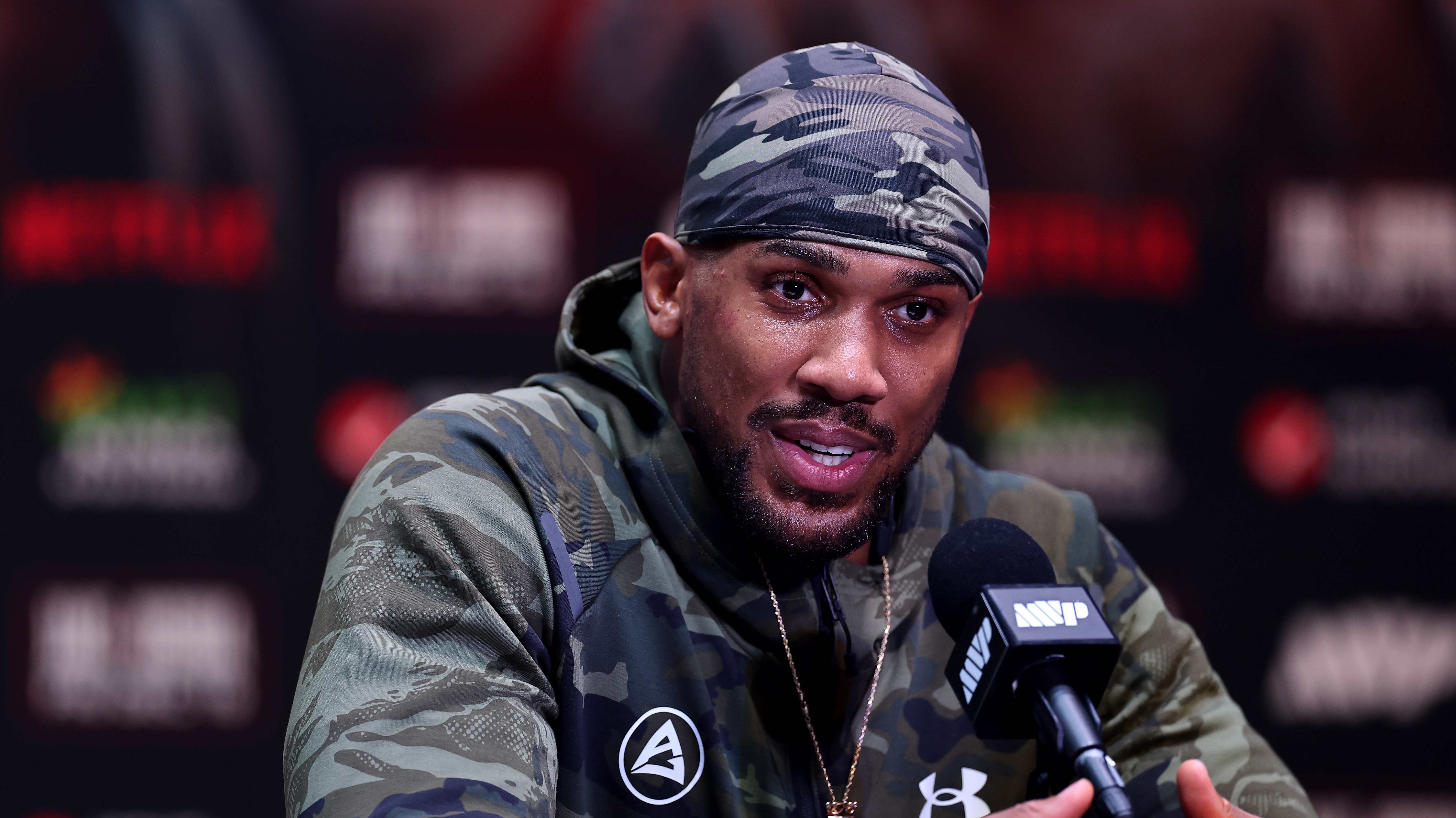 MIAMI, FLORIDA - DECEMBER 19: Anthony Joshua speaks at a press conference after Jake Paul v Anthony Joshua at Kaseya Center on December 19, 2025 in Miami, Florida. (Photo by Carmen Mandato/Getty Images for Netflix)
