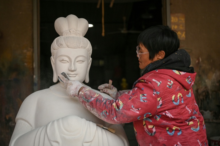World AFP China's Buddha artisans carve out a living from dying trade
