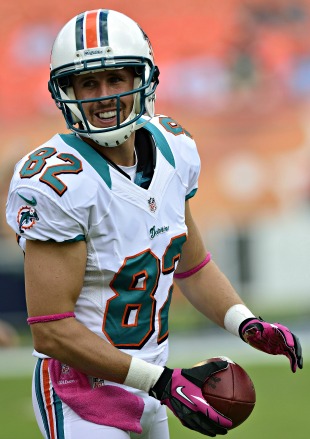 Miami Dolphins' Brian Hartline, top, makes a touchdown catch under