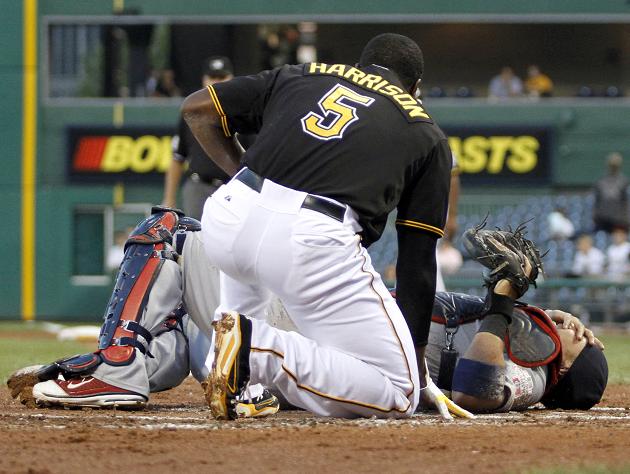 St. Louis Cardinals catcher Yadier Molina adjusts his mask as he