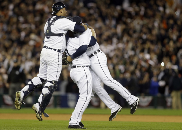 Touchdown! Phil Coke celebrates AL pennant by spiking glove before start of  Tigers party