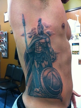 Micro-realistic style Spartan warrior tattoo located on