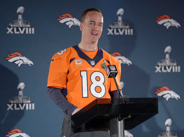 Peyton Manning of the AFC team holds his MVP trophy after the NFL