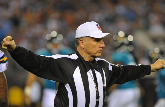 London, UK. 13 October 2019. The referee, Walt Anderson, views a Microsoft  Surface tablet for a Play Under Review incident during the NFL match Tampa  Bay Buccaneers v Carolina Panthers at Tottenham