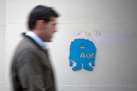 A man walks past the AOL logo at the company's office in New York