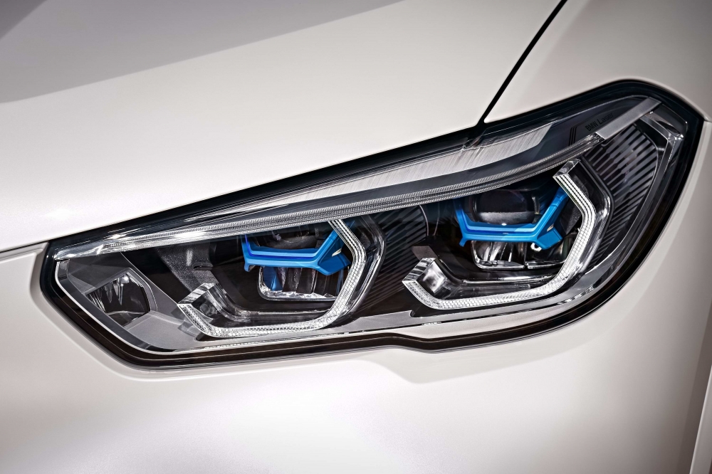 前衛設計智慧雷射頭燈以湛藍色「X」型燈組搭配經典四環造型呈現，照明距離高達500m（圖片來源：BMW）