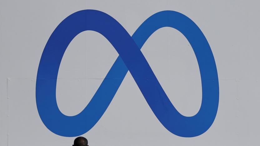 A man stands in front of a sign of Meta, the new name for the company formerly known as Facebook, at its headquarters in Menlo Park, California, U.S. October 28, 2021. REUTERS/Carlos Barria     TPX IMAGES OF THE DAY