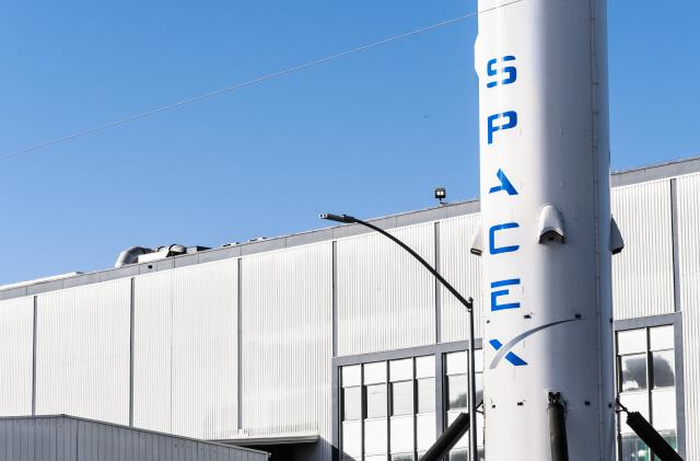 Dec 8, 2019 Hawthorne / Los Angeles / CA / USA - SpaceX (Space Exploration Technologies Corp.) headquarters; Falcon 9 rocket displayed in the front; SpaceX is a private American aerospace manufacturer