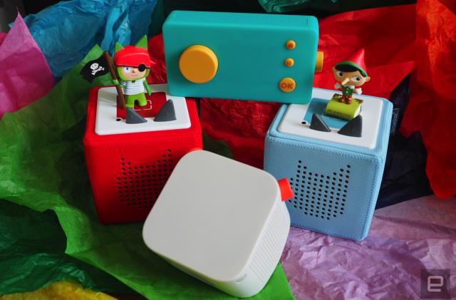 Two Tonieboxes, a Yoto Player and a Lunii on a bed of colored tissue paper