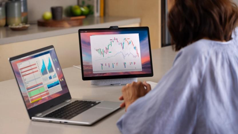 Photo of a woman using Duet Display to extend her MacBook screen to a Meta Portal Plus smart display. 