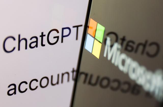 ChatGPT website displayed on a laptop screen and Microsoft logo displayed on a phone screen are seen in this illustration photo taken in Krakow, Poland on February 26, 2023. 