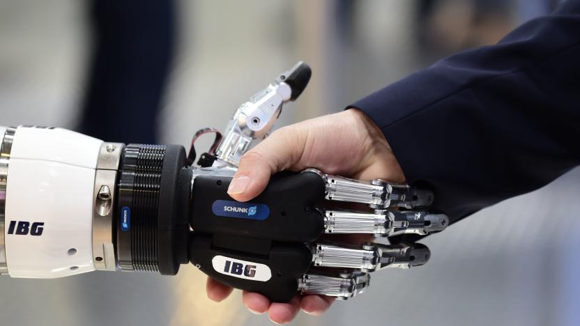 A person shakes hand with a robot at the booth of IBG Automation during the Hanover Fair ('Hannover Messe') on April 23, 2018 in Hanover, northern Germany. - The Hanover technology fair runs until April 28, 2018, with Mexico as partner country. (Photo by Tobias SCHWARZ / AFP)        (Photo credit should read TOBIAS SCHWARZ/AFP via Getty Images)