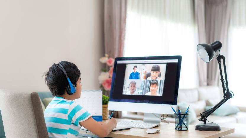 Asian boy student video conference e-learning with teacher and classmates on computer in living room at home. Homeschooling and distance learning ,online ,education and internet.