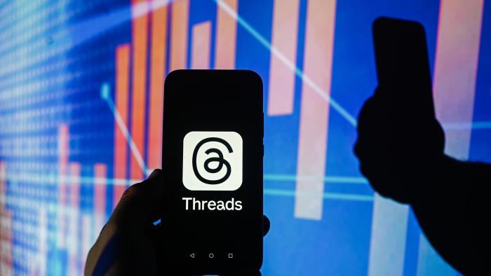 POLAND - 2023/12/14: In this photo illustration a Meta Threads logo is displayed on a smartphone with stock market percentages in the background. (Photo Illustration by Omar Marques/SOPA Images/LightRocket via Getty Images)