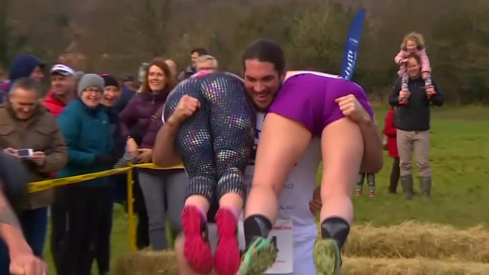 An American couple retain their title in the UK's wife carrying ch...