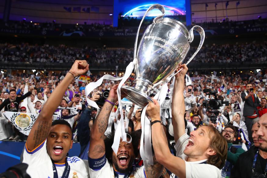 PARIS, FRANCE - MAY 28:   Luka Modric, Rodrigo and Marcelo of Real Madrid celebrate with the trophy following their sides victory at the end of the UEFA Champions League final match between Liverpool FC and Real Madrid at Stade de France on May 28, 2022 in Paris, France. (Photo by Chris Brunskill/Fantasista/Getty Images)