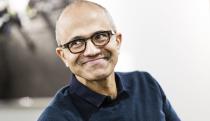 Photo of Microsoft CEO Satya Nadella looking to his right and grinning knowingly.