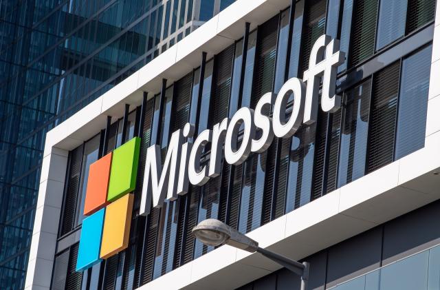 26 March 2021, Bavaria, Munich: The Microsoft logo hangs on the facade of an office building in Parkstadt Schwabing, in the north of the Bavarian capital. Photo: Peter Kneffel/dpa (Photo by Peter Kneffel/picture alliance via Getty Images)