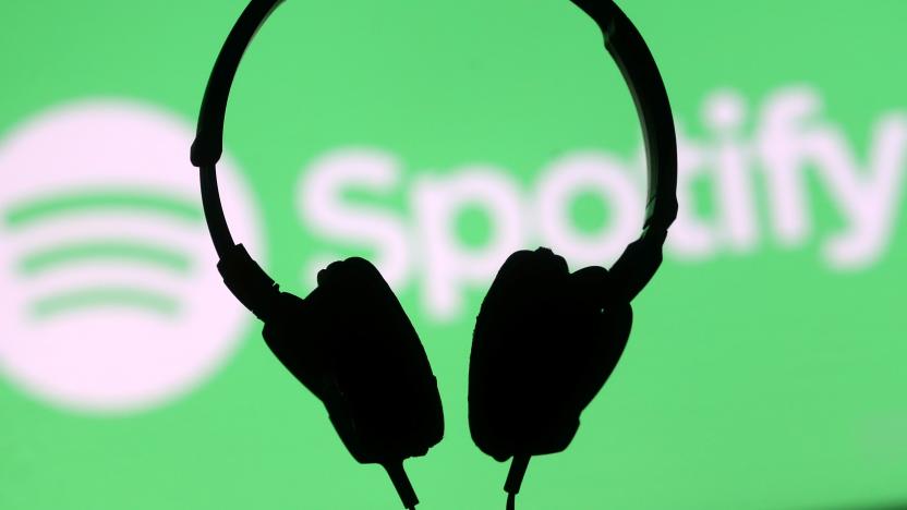 A headset is seen in front of a screen projection of Spotify logo, in this picture illustration taken April 1, 2018. REUTERS/Dado Ruvic/Illustration