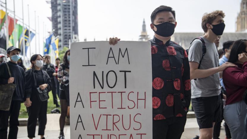 PARLIAMENT SQUARE, LONDON, UNITED KINGDOM - 2021/07/24: A demonstrator wearing Chinese traditional jacket holds a placard  outside Parliament Square during the Stop Asian Hate rally in London.
Demonstrators held a protest against the increasing anti-Asian hate and racism in the wake of the coronavirus pandemic. (Photo by May James/SOPA Images/LightRocket via Getty Images)