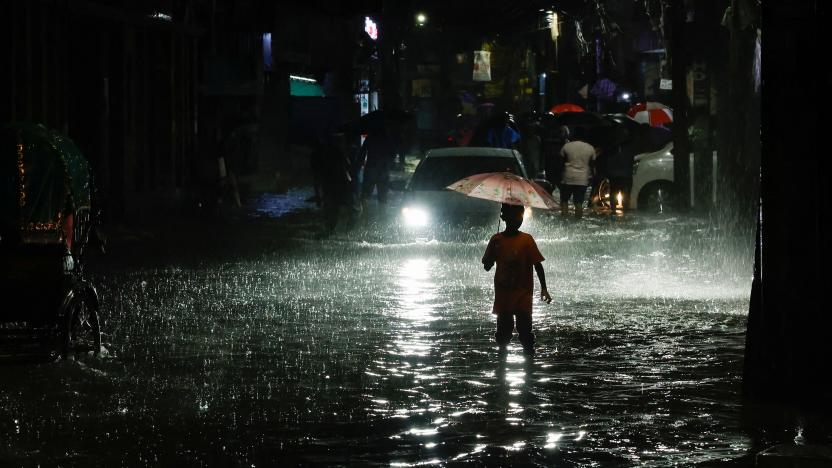 A boy wades through water as streets are flooded due to continuous rain, before the Cyclone Sitrang hits the country in Dhaka, Bangladesh, October 24, 2022. REUTERS/Mohammad Ponir Hossain