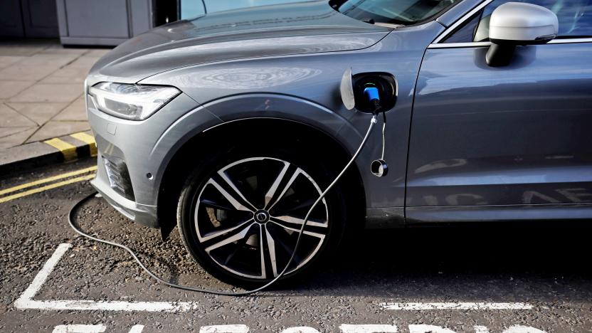 An EV charging next to the word "electric" painted on the pavement.