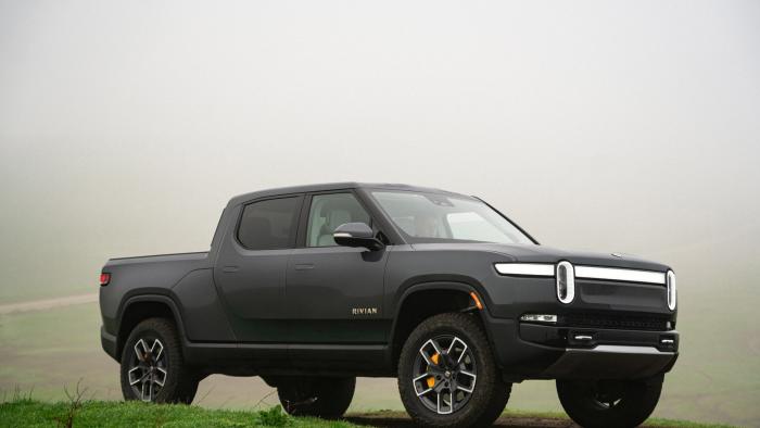 A dark gray truck parked on the grass.