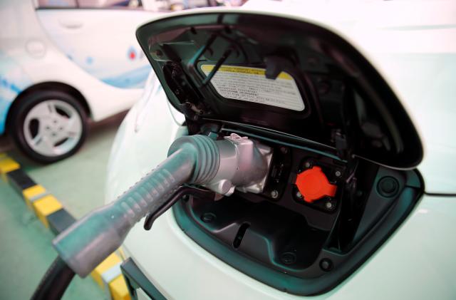 An electric car is seen while being charged during the opening of a PTT Pcl energy firm's commercial EV (Electric Vehicle) charging station, in Bangkok, Thailand August 15, 2016. REUTERS/Jorge Silva