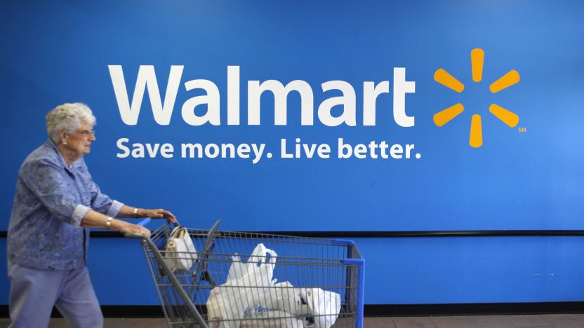 A customer leaves a Wal-Mart store in Rogers, Arkansas June 4, 2009. Wal-Mart Stores Inc said on Thursday that its strong financial position leaves it well positioned to take advantage of acquisition opportunities across the globe.      REUTERS/Jessica Rinaldi (UNITED STATES BUSINESS)