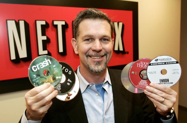 Reed Hastings, CEO of Netflix Inc., the online DVD-rental service, holds several DVDs as he poses at the Netflix offices in Beverly Hills, California, December 8, 2005. [Netflix has come out on top in a yearlong struggle against rival Blockbuster Inc. ]