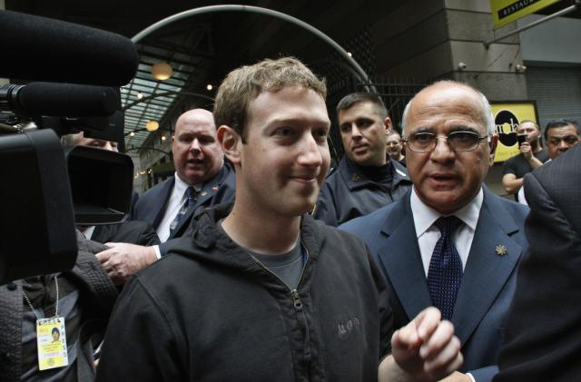 Facebook Inc. CEO Mark Zuckerberg is escorted by security guards as he departs New York City's Sheraton Hotel May 7, 2012. Facebook Inc kicked off its IPO roadshow in New York on Monday, attracting hundreds of investors to the Sheraton as the world's largest social network aims to raise about $10.6 billion, dwarfing the coming-out parties of tech companies like Google Inc and granting it a market value close to Amazon.com Inc's.   REUTERS/Eduardo Munoz    (UNITED STATES - Tags: BUSINESS SCIENCE TECHNOLOGY)