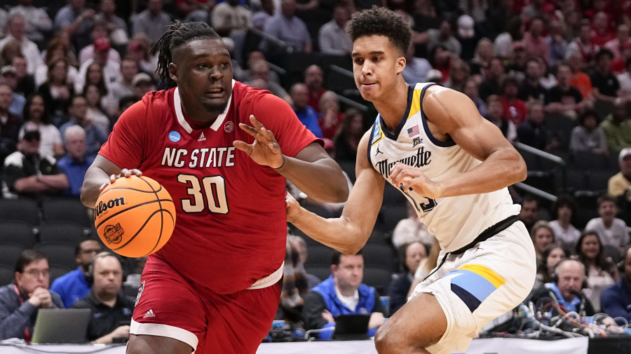 Associated Press - North Carolina State's DJ Burns Jr. (30) drives against Marquette's Oso Ighodaro during the first half of a Sweet 16 college basketball game in the men's NCAA Tournament in Dallas, Friday, March 29, 2024. (AP Photo/Tony Gutierrez)