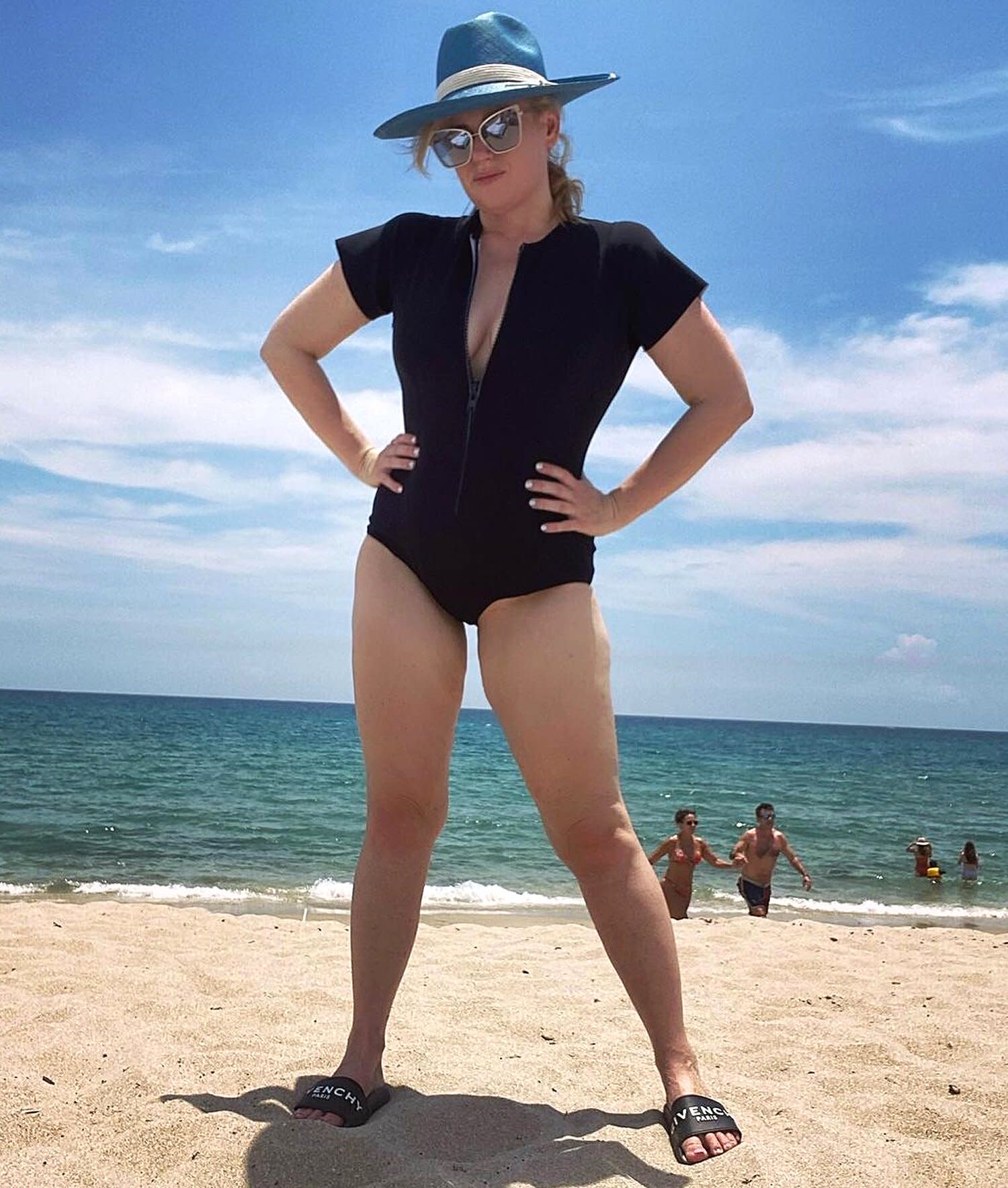 Rebel Wilson Hits the Beach in a Curve-Hugging Swimsuit and Givenchy Slides - Yahoo Entertainment