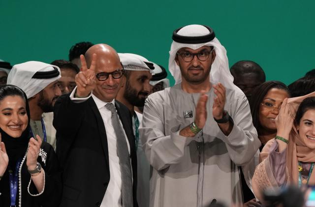 United Nations Climate Chief Simon Stiell, from left, and COP28 President Sultan al-Jaber pose for photos at the end of the COP28 U.N. Climate Summit, Wednesday, Dec. 13, 2023, in Dubai, United Arab Emirates. (AP Photo/Kamran Jebreili)