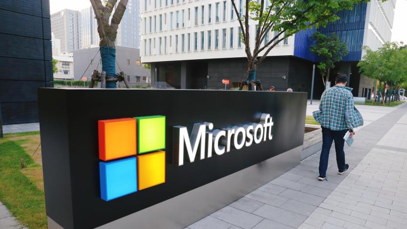 SHANGHAI, CHINA - JUNE 06: A man walks past a logo of Microsoft outside an office building at Shanghai Caohejing Hi-Tech Park on June 6, 2020 in Shanghai, China. (Photo by Chen Yuyu/VCG via Getty Images)