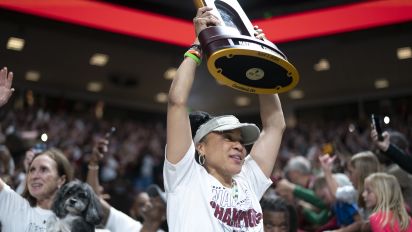 Getty Images - COLUMBIA, SOUTH CAROLINA - APRIL 8:  South Carolina coach Dawn Staley raises the NCAA Women's Basketball Championship trophy during a celebration at the Colonial Life Arena on April 8, 2024 in Columbia, South Carolina. University classes that were scheduled during the event were canceled. The South Carolina Gamecocks defeated the Iowa Hawkeyes 87-75 to cap a perfect season. 
 (Photo by Sean Rayford/Getty Images)